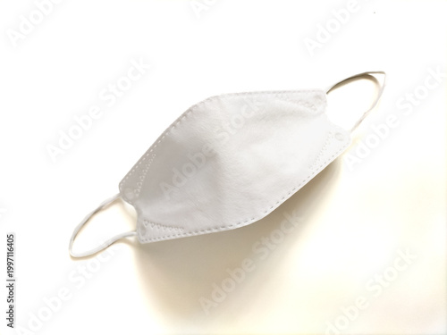White face mask with a structured, contoured design and elastic ear loops. Typical of masks used for respiratory protection in healthcare and public settings.