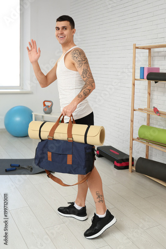 Young man with sports bag a...
