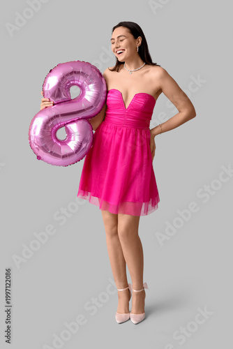 Happy young woman with pink...
