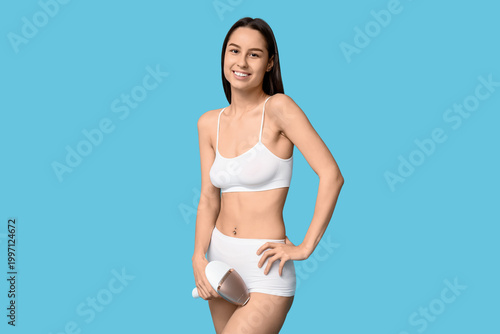 Smiling young woman in whit...