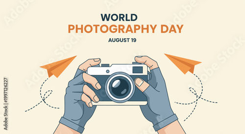 Hands in fingerless gloves holding a vintage camera with paper planes flying in the background for World Photography Day August 19 World Photography Day
