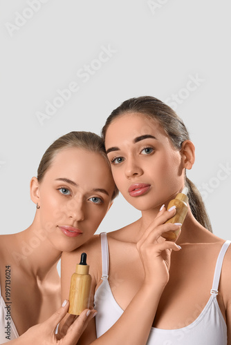 Young women with bottles of...