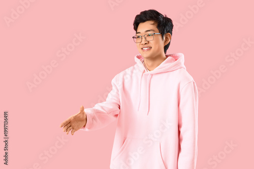 Young Asian man reaching ou...