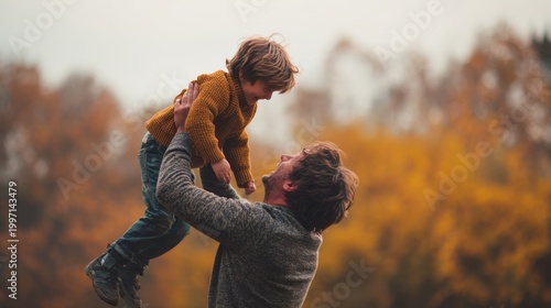 Playful Affection: A father joyfully lifts his child high in the air, creating a moment of pure, unadulterated happiness amidst the colorful backdrop of autumn.