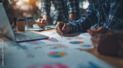 Strategic Planning: A collaborative team gathers around a table, analyzing charts and data to refine their business strategies. This image captures the essence of strategic planning, problem-solving.