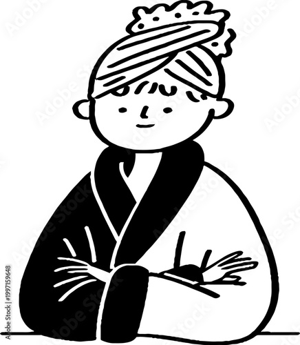 Young person with towel turban sitting with arms crossed indoors