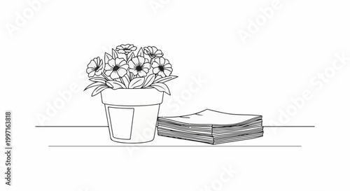 A potted flowering plant sits next to a stack of papers on a surface