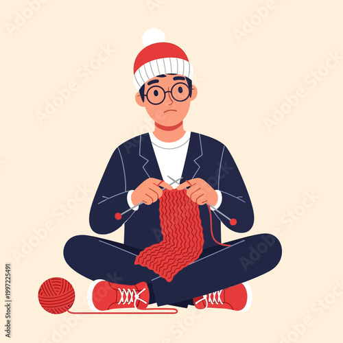 Man wearing hat sitting and knitting a red scarf