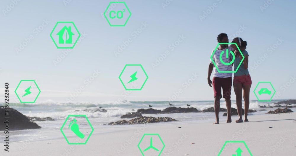 Naklejka premium Walking couple wearing casual beachwear along wet sand, green hex overlays with icons, copy space