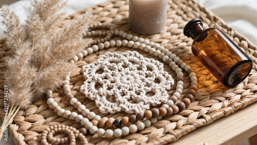 Boho Decor Flatlay with Macrame Coaster, Pampas Grass, Amber Glass Bottle, Ceramic Beads and Neutral Candle on Woven Rattan in Soft Natural Light