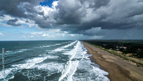 Dramatic and ominous sky over a vast empty coastline with waves