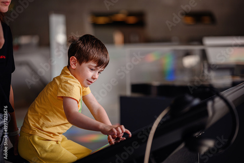 Young student sitting at interactive digital station in gallery, modern education technology