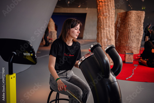 Quadro em tela Female visitor exploring interactive sound exhibit at science and technology mus