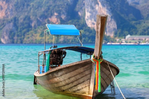 Wooden Boat Anchored in Blue Water Near Rocky Mountains on a Sunny Day