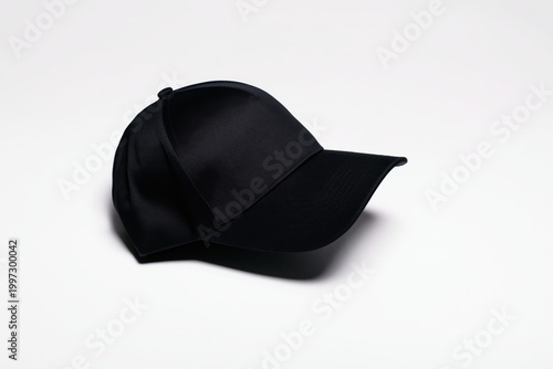 Black Cap Placed on a White Surface at a Simple Indoor Setting