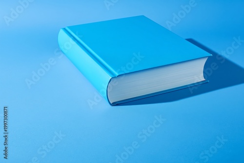 Simple Blue Book on a Blue Background Showing the Cover and Pages