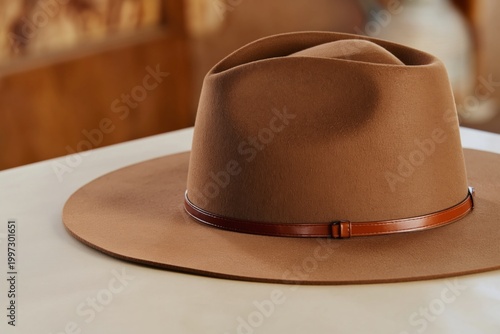 Brown Wide-Brim Hat Placed on a Light-Colored Table in an Indoor Setting Duri...