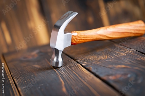 Wooden Hammer Rests on a Rustic Wooden Surface in a Craft Workshop During the...