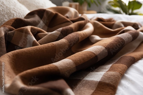 Soft Brown Blanket Draped on a Bed With White Sheets in a Cozy Room During Da...