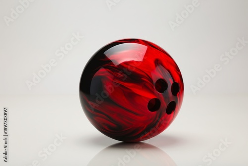 Bowling Ball With Red and Black Swirl Design Sits on a Simple Surface