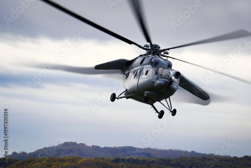 Military Helicopter Flies Over a Green Landscape With Hills on a Cloudy Day