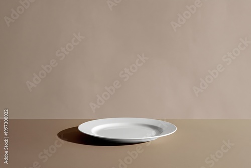 Plain White Plate Resting on a Simple Table Surface in a Calm Room Setting Du...