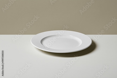 Plain White Plate Resting on a Simple Table Surface in a Calm Room Setting Du...