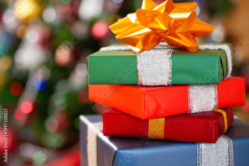 Colorful Gift Boxes Stacked for a Holiday Celebration in Front of a Decorated...