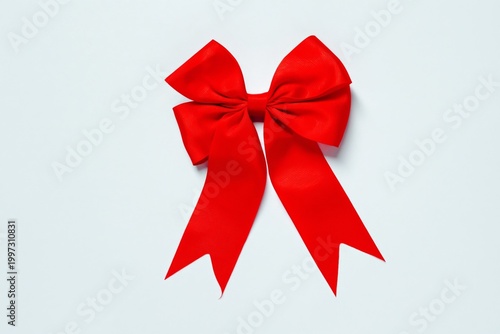 Red Bow With Long Ribbons Tied in a Knot for Use in Crafts or Decorations