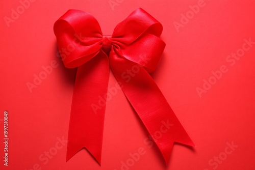 Bright Red Bow Placed on a Red Background for Decoration or Gift Wrapping Pur...