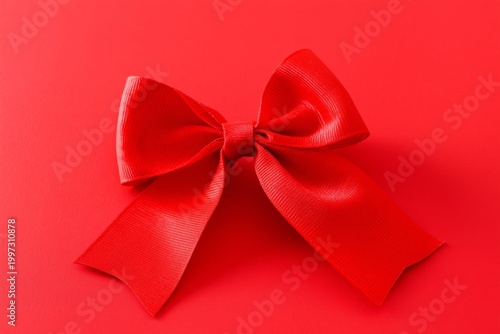 Bright Red Bow Placed on a Red Background for Decoration or Gift Wrapping Pur...
