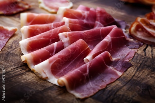Cured Meat Slices Arranged Neatly on a Wooden Board for Preparation or Serving