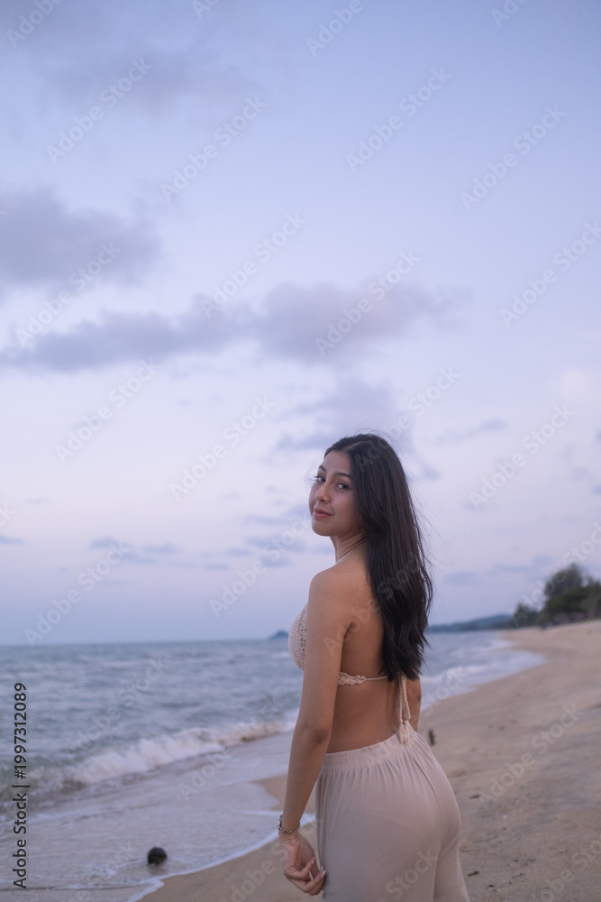 Obraz premium Portrait gorgeous charming relaxed Asian woman lady girl female sitting performing meditation beach sand ocean sea. Happy woman walking on beach