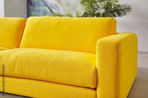 Bright Yellow Sofa in a Modern Living Room With Green Plants and Colorful Art...