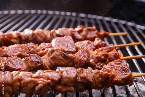 Grilling Skewers of Meat on a Barbecue During a Cookout in the Backyard in th...