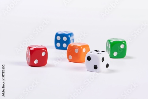 Colorful Dice Are Scattered on a White Surface for a Game or Activity