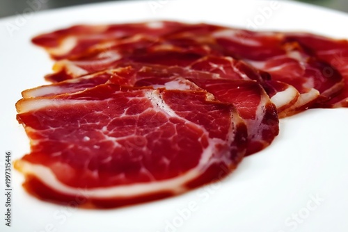 Slices of Red Cured Meat Arranged in a Row on a White Background for a Food D...
