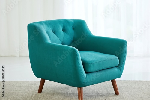 Turquoise Armchair Placed on a Rug in a Well-Lit Indoor Space With White Curt...