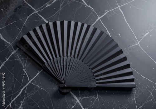 Blank black folding hand fan mockup lying on marble, ai generated. Empty open vintage paperfan for summer accessory, top view. Clear wind air or interior pleated handfan for cooling or decor template.