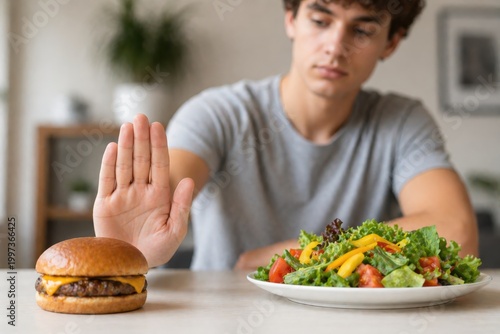 Man refusing burger for healthy salad diet choice.