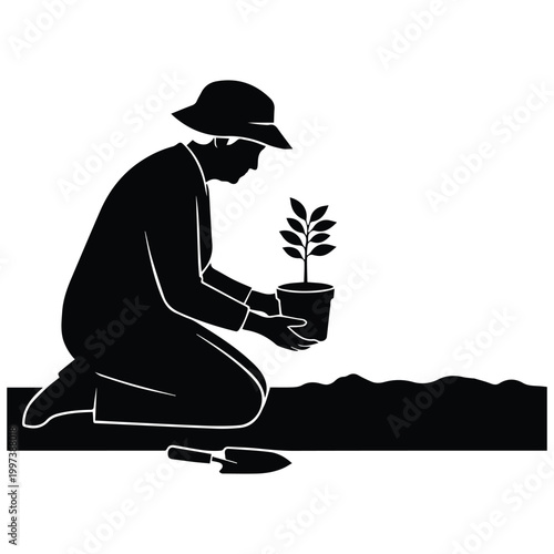 Person silhouette planting a tree in a pot for environmental care