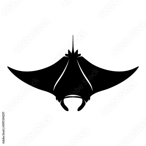 Silhouette of a majestic manta ray gracefully gliding through the ocean depths.