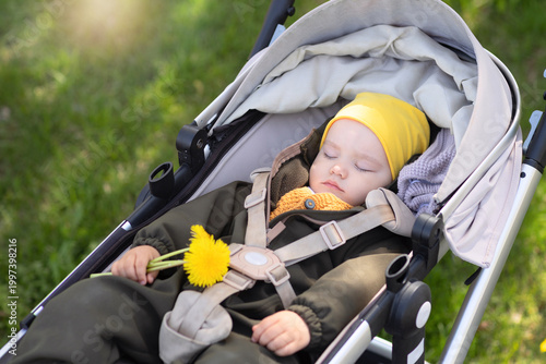 Happy baby in his stroller during an outdoor walk