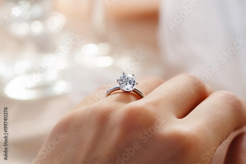 Ring on Hand With Diamond Sitting on a Table During a Special Moment in a Bri...
