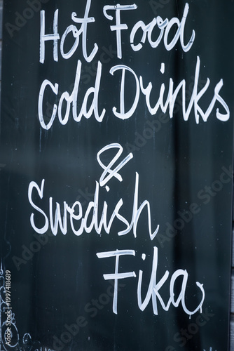 Stockholm, Sweden A blackboard sign says Hot Foods  Cold Drinks and Swedish Fika.