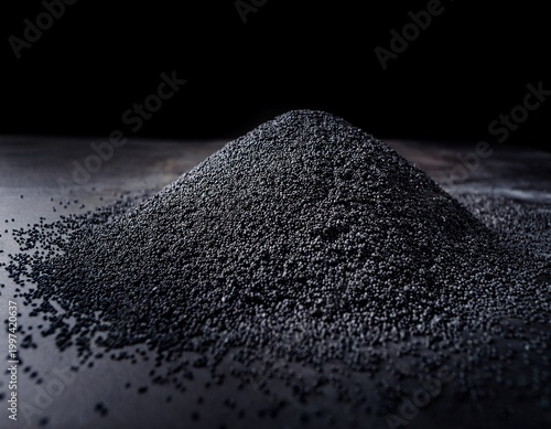 pile of fine black grains on dark surface