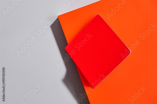 Bright Notebook Placed on Orange Surface With Gray Background During Daytime