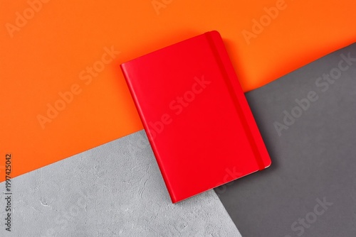 Bright Notebook Placed on Orange Surface With Gray Background During Daytime