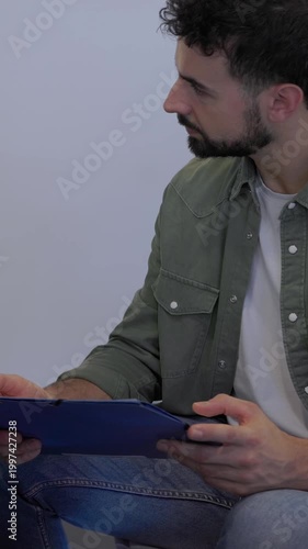 Vertical HD video of diverse team brainstorming together in an informal office meeting. Coworkers sharing ideas and discussing solutions in a relaxed collaborative environment