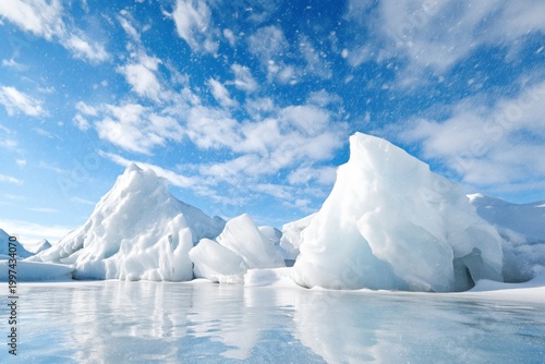 Icebergs Float in Calm Water Under a Blue Sky With Clouds During the Day in a...